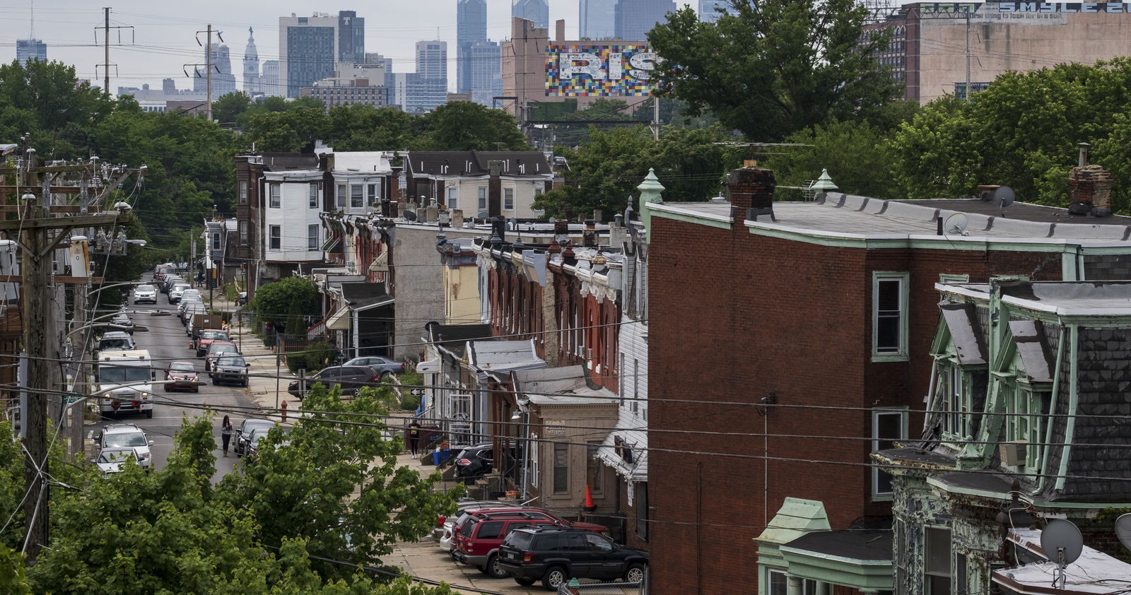 a street in north philadelphia with the center city skyline in the background