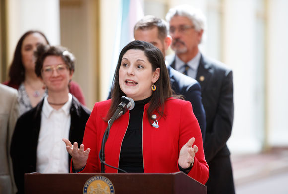 amanda cappelletti stands at a podium during a speech