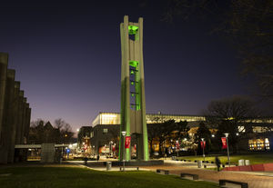 temple belltower lit with green lights