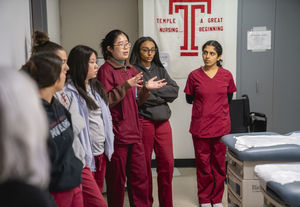nursing students observe during a simulation.