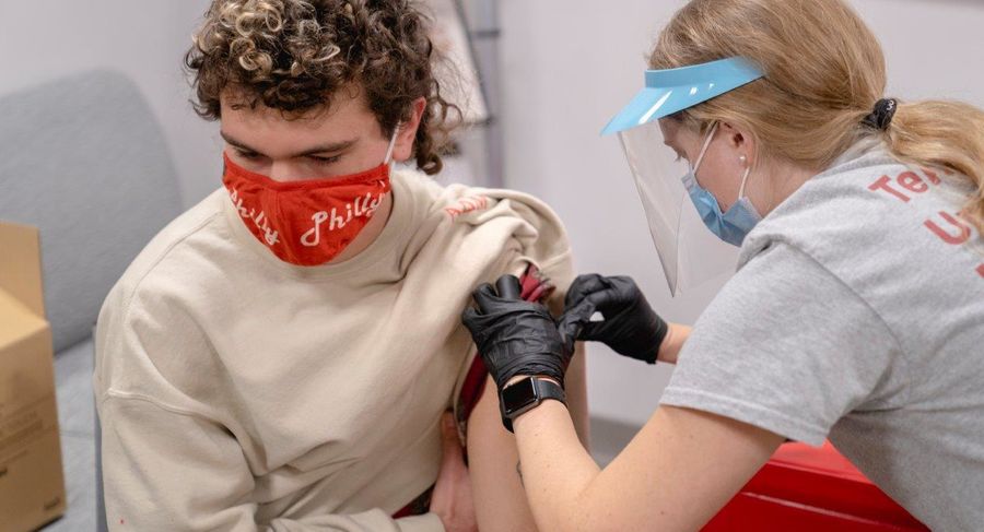 a student receives a covid-19 vaccine