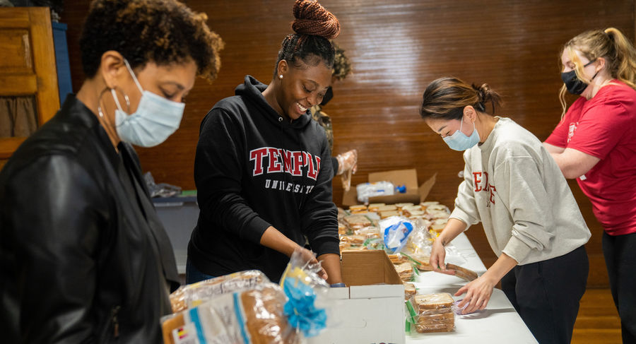 Four volunteers preparing sandwiches