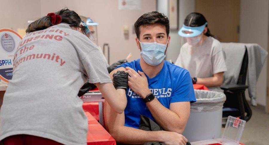 a student receives a covid-19 vaccination