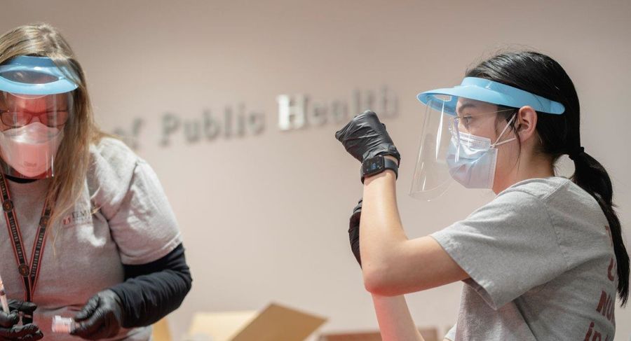 student prepares syringe for covid-19 vaccine