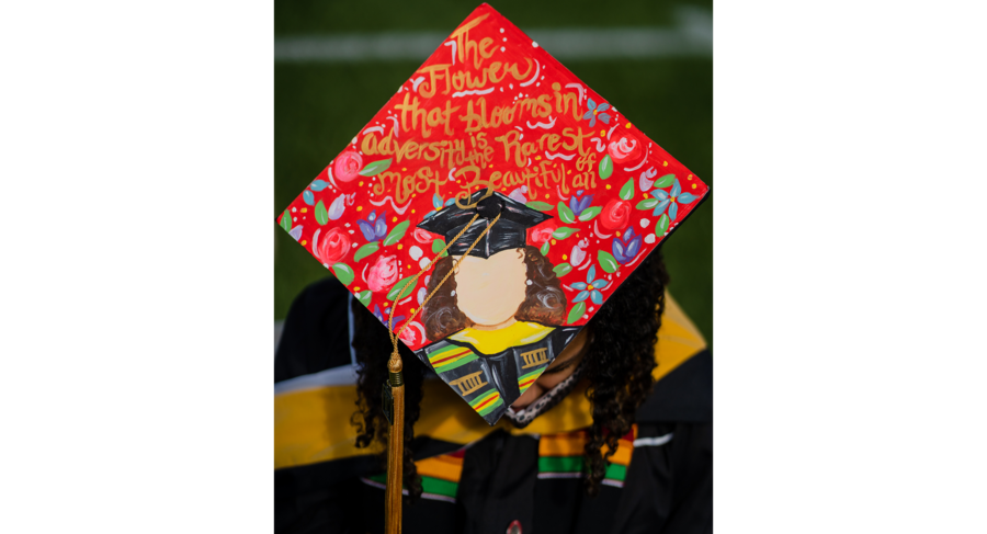 a graduation cap with the words the flower that blooms in adversity is the rarest and most beautiful of all