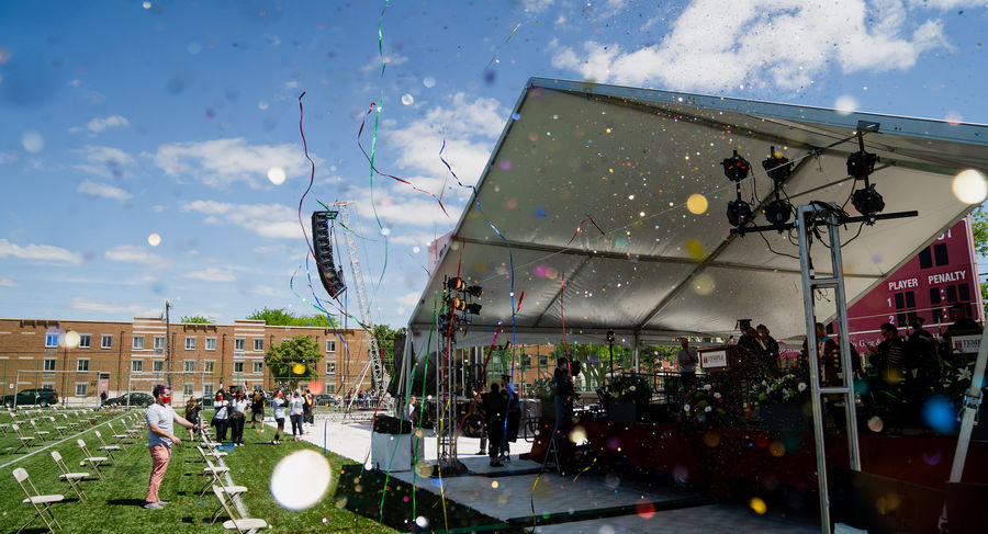 the graduation stage on geasey field with confetti flying through the air