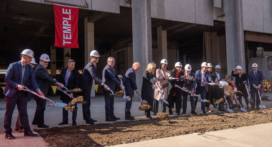 A group of people, with shovels in hand, breaking ground on the new Paley Hall