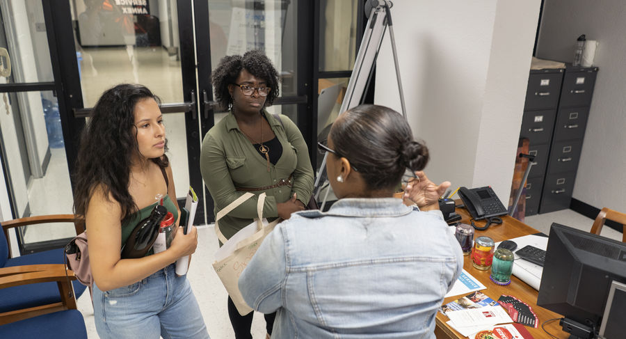 Two students speaking with a member of SS Annex staff