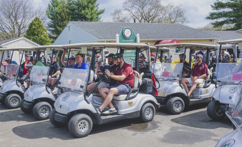 Group of participants riding golf carts