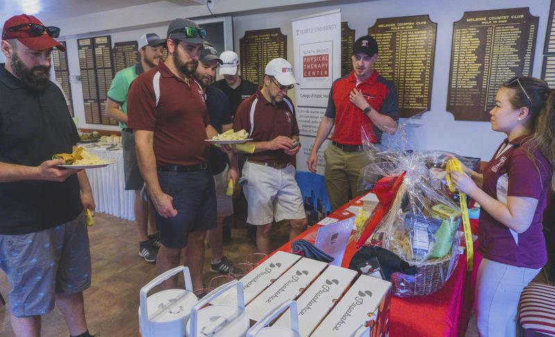 Participants choosing golf clubs