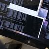 A faculty member looks at a black computer screen with data on it in white text