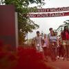 An orientation leader walks new students through campus