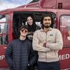 Students stand in front of a helicopter