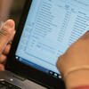 Man pointing at data on a screen