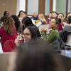 Students in class are laughing with their professor