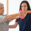 OT helping woman lift her arms