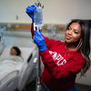 Nursing student checking and iv bag