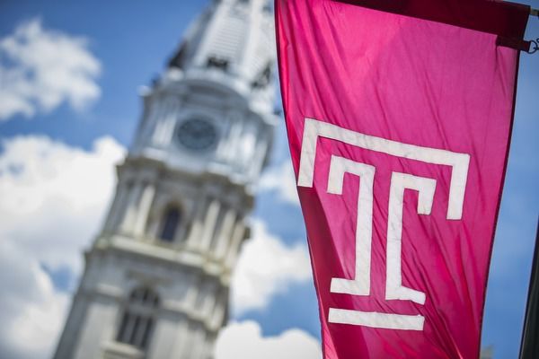 temple university flag with philadelphia city hall in the background