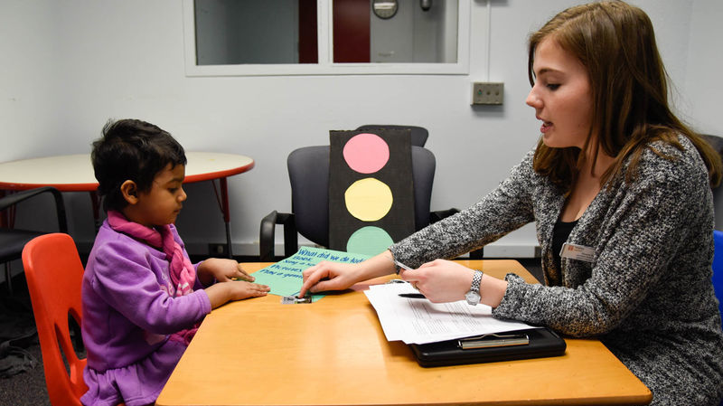 Speech pathologist working with small child