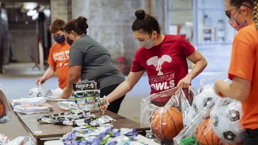 people packing bags of at-home sports equipment 