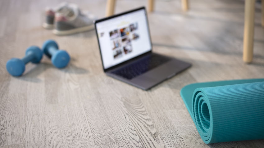yoga mat, online fitness class, and dumbbells