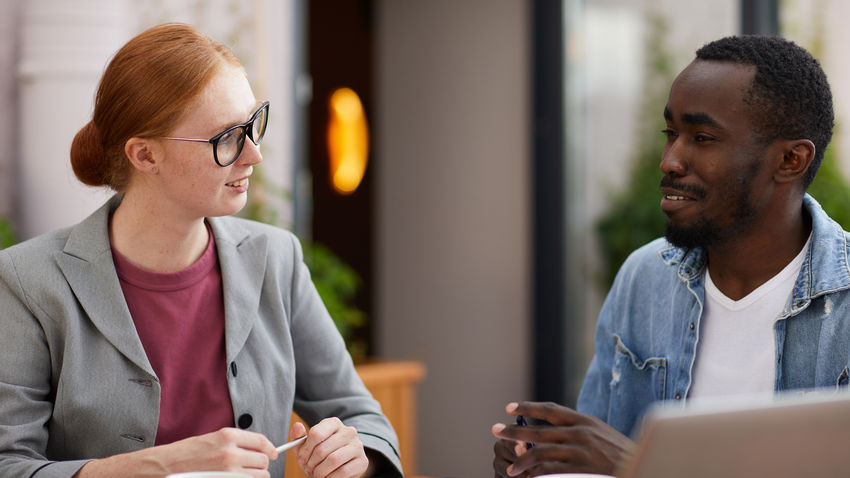 a lawyer sits at a table with a client