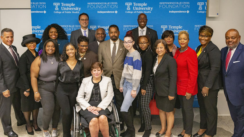 Temple students and administrators, IBC personnel, and government representatives posing for a photo at a press conference