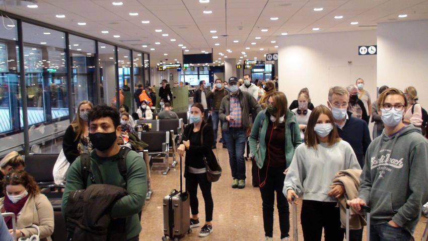 a group of masked people in an airport