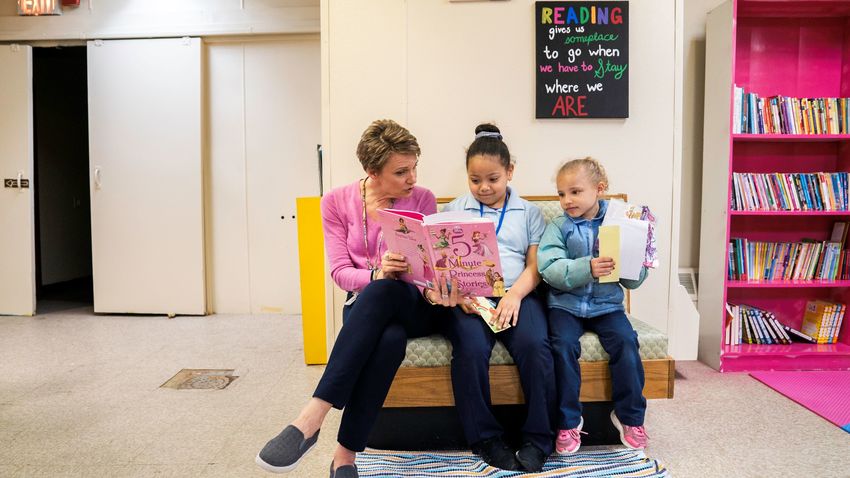 Laura Rauth reading to students in the library at Webster elementary