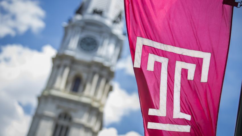 temple university flag with philadelphia city hall in the background