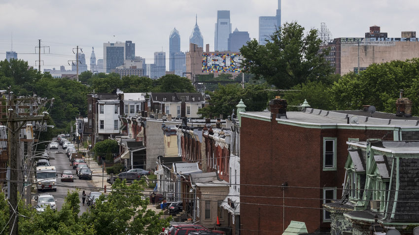 an aerial view of a north philadelphia neighborhood with the philadelphia skyline in the background