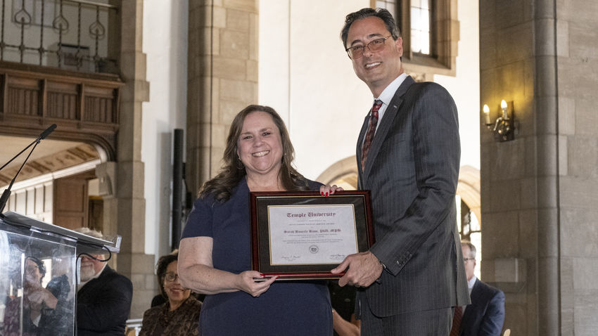Sarah Bass receives an award from Provost Gregory Mandel
