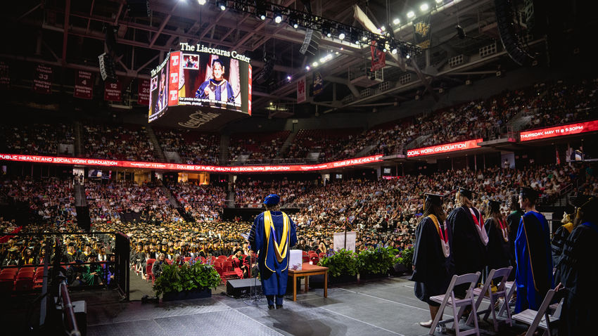 interim dean jennifer ibrahim stands on the stage in the liacouras center facing graduating students in the Class of 2023.