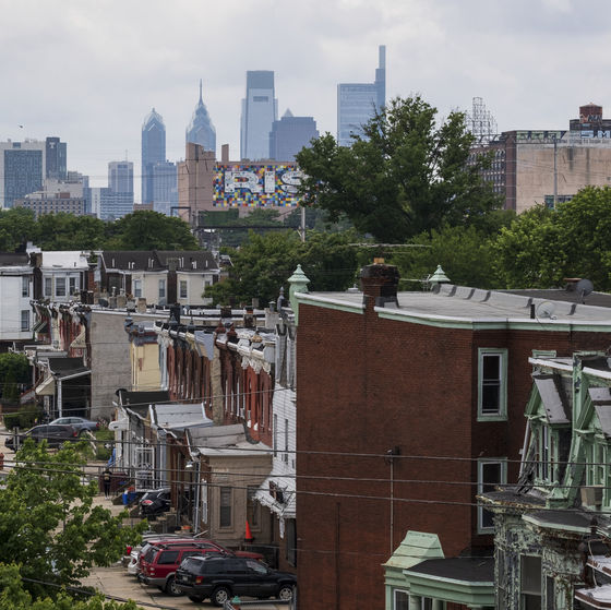 an aerial view of a north philadelphia neighborhood with the philadelphia skyline in the background