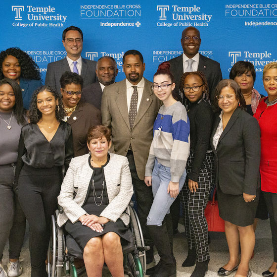 Temple students and administrators, IBC personnel, and government representatives posing for a photo at a press conference
