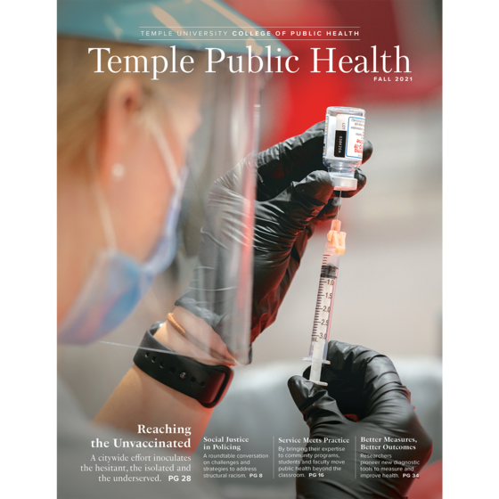 the cover of the college of public health 2021 magazine, depicting a nursing student filling a needle with covid-19 vaccine