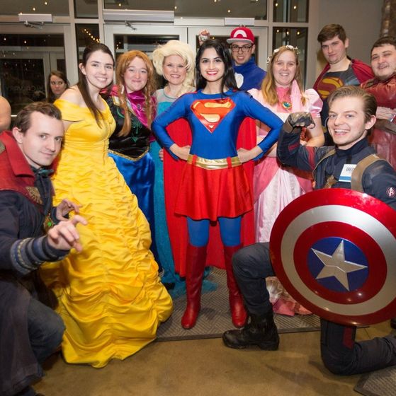 students visiting hospital or school as superheroes