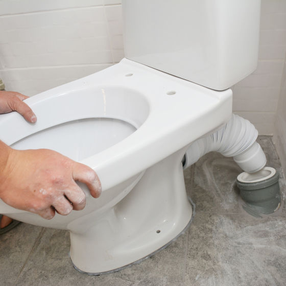 person installing toilet