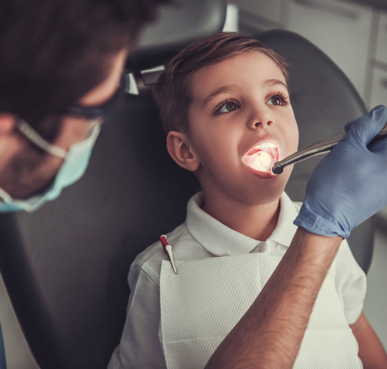 Dentist examining boy's teeth